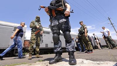 A reader calls for Russian president Vladimir Putin and the pro-Russian rebels, pictured guarding a train containing victims’ bodies, to allow a full inquiry into the down ing of MH17. Robert Ghement / EPA