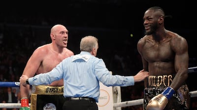 Tyson Fury taunts Deontay Wilder. AP Photo