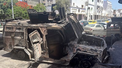 The burnt shell of a vehicle following overnight clashes in Tripoli, Libya, on Tuesday. EPA