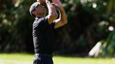 Tiger Woods tosses his ball on the ninth green. Getty