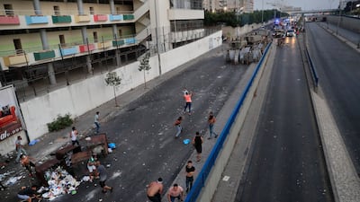 Demonstrators confront armoured vehicles in Beirut. Saad Hariri stepped down after nine months of trying to form a Cabinet.