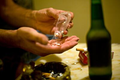 A young drug user divides a stash of generic prescription drugs used by street kids in the Hezbollah-controlled southern suburbs of Beirut. Mitchell Prothero / The National
