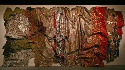 The Ghanaian artist El Anatsui's In the World But Don't Know the World is made of thousands of crimped and flattened pieces of scrap metal.