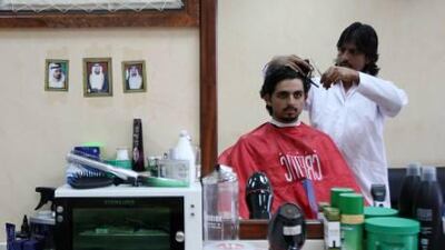 Irfan Sultan Ahmed cutting a customer's hair at his Silver Gents Salon in Al Barsha in Dubai.