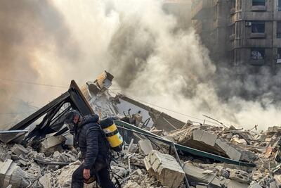 A firefighter inspects destruction at a site of an Israeli airstrike in the southern suburbs of Beirut. AFP