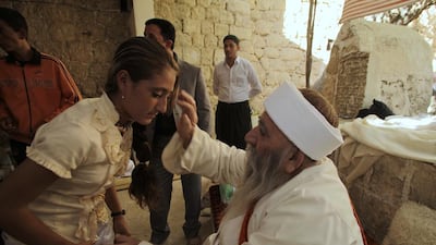 A Yazidi religious leader blesses a worshipper in northern Iraq, during the community’s main festival of Eid al-Jamma. Reuters