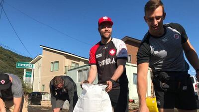 Handout photo taken with permission from the Twitter feed of members of the Canadian rugby team, whose match against Namibia was cancelled, helping to clear roads after typhoon Hagibis saw torrential rain and tornado-like winds hit large parts of Japan. PA Photo. Issue date: Sunday October 13, 2019. See PA story RUGBYU Namibia Canada. Photo credit should read: @worldrugby/@rugbycanada/PA Wire NOTE TO EDITORS: This handout photo may only be used in for editorial reporting purposes for the contemporaneous illustration of events, things or the people in the image or facts mentioned in the caption. Reuse of the picture may require further permission from the copyright holder.PA Photo. Issue date: Sunday October 13, 2019.
