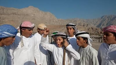 Saif Al Nar, centre, demonstrates the nadbah to his friends in the Ras Al Khaimah village of Al Jeer. He began nadbah calling at the age of six when his talent was noticed by tribal elders.