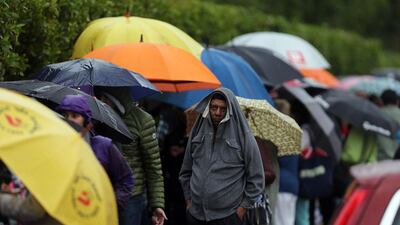 Tennis fans were not deterred by the rain and cold early on Monday morning as they queued for tickets to the Dubai Duty Free Tennis Championships. Satish Kumar / The National