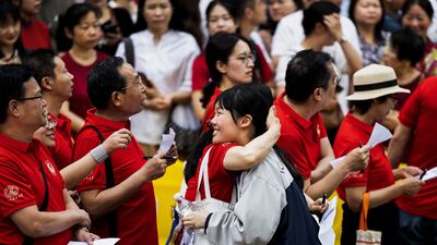 A pupil hugs a teacher outside a school on the first day of the national college entrance examination, known as Gaokao, in Wuhan, China. AFP