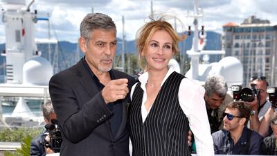 George Clooney and Julia Roberts, in Givenchy, attend the 'Money Monster' photocall during the 69th annual Cannes Film Festival at the Palais des Festivals on May 12, 2016 in Cannes, France. Getty Images