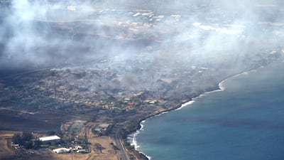 Smoke rises above Lahaina in this handout photo courtesy of Carter Barto via Facebook. AFP