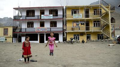 Two girls play in front of newly constructed hotels in Kaza, headquarters of the Spiti Valley. Thomas Cytrynowicz / AP Photo