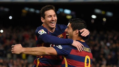 Barcelona's Uruguayan forward Luis Suarez (R) celebrates a goal with Barcelona's Argentinian forward Lionel Messi during the Spanish league football match FC Barcelona vs RC Celta de Vigo at the Camp Nou stadium in Barcelona on February 14, 2016.