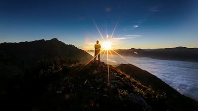 A man enjoys the sunrise on Hundskopf mountain in the western Austrian village of Gnadenwald, Austria. Dominic Ebenbichler / Reuters