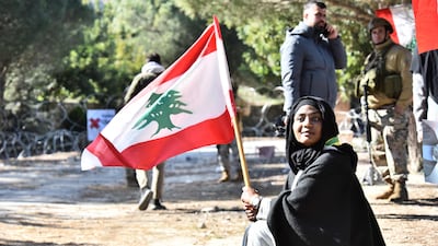 Residents of a southern Lebanese village gather near a roadblock set up by Israeli soldiers. AFP