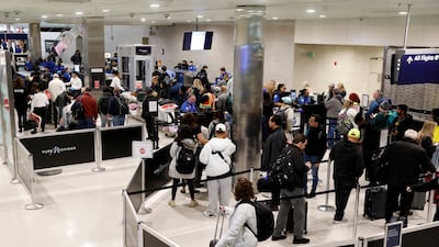 Passengers queue to go through security amid disruption at Detroit Metro Airport in Romulus, Michigan. AFP