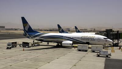 Passenger aircraft stand on the tarmac at Muscat International Airport in Oman. Bloomberg