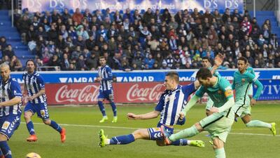 Barcelona’s Lionel Messi, right, scores against Alaves. Jose Ramon Gomez / EPA