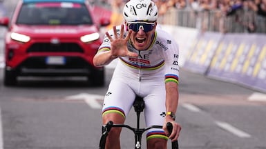 Reigning World Champion Tadej Pogacar indicates five as he celebrates winning his fifth in a row Il Lombardia, Tour of Lombardy cycling race, in Bergamo, Italy, Saturday, Oct. 11, 2025. (Marco Alpozzi / LaPresse via AP)