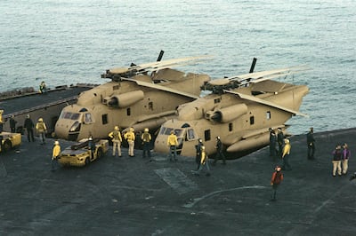 Crew on the aircraft carrier USS Nimitz preparing RH-53 Sea Stallion helicopters for Operation Eagle Claw in 1980. USN