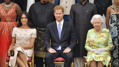 Meghan and Prince Harry with Queen Elizabeth II at the Queen's Young Leaders Awards Ceremony at Buckingham Palace in June 2018. Getty Images