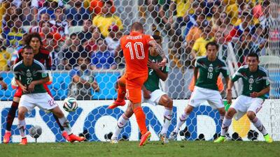Wesley Sneijder of the Netherlands shoots and scores his team's first goal for the 1-1 equaliser past Guillermo Ochoa of Mexico during the 2014 World Cup in Fortaleza, Brazil on Sunday. Robert Cianflone / Getty Images
