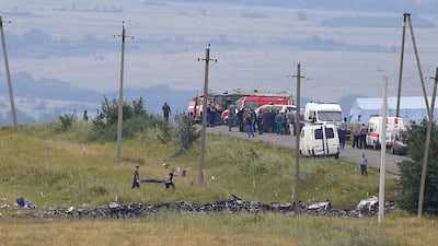 Two workers carry the remains of a passenger at the main crash site of the Boeing 777 Malaysia Airlines flight MH17, which crashed during flying over the eastern Ukraine region, some 100 Km east from Donetsk, Ukraine. EPA/ROBERT GHEMENT