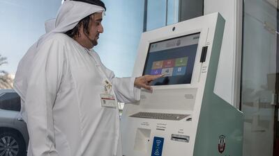 Saeed Al Romaithi, director of TransAD’s information and communication technology department, checks out the self-service kiosk. Vidhyaa for The National