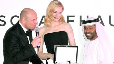 Waleed Al Shehhi is presented with his award by Georges Kern, left, and Cate Blanchett on stage at For The Love of Cinema - IWC Filmmakers Award during day two of the 10th Annual Dubai International Film Festival held at the One and Only Mirage Hotel on December 7, 2013 in Dubai, United Arab Emirates. Gareth Cattermole / Getty Images for DIFF