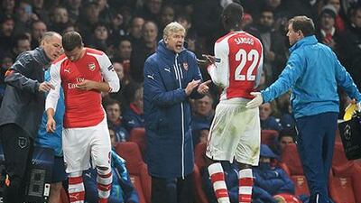 Arsene Wenger, centre, was pleased with Yaya Sanogo's performance against Dortmund on Wednesday night. Andy Rain / EPA