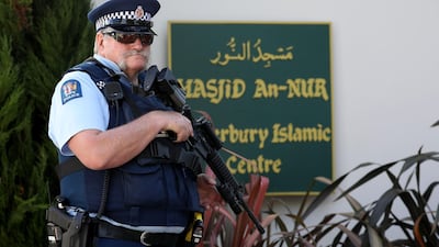 An armed police officer stands guard outside the Al Noor mosque, following the Christchurch terror attack. AFP / Sanka Vidanagama