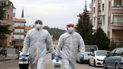 Health workers wearing protective gear against coronavirus take their medicine to a patient who has been tested positive in Ankara amid the Covid-19 pandemic. AFP