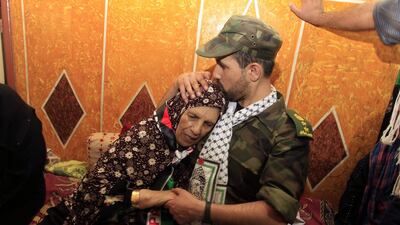 Freed Palestinian prisoner Salah al-Sahair, who was held by Israel for 21 years, kisses his mother on the head following his return to the family home in Khan Younis. AFP PHOTO / SAID KHATIB