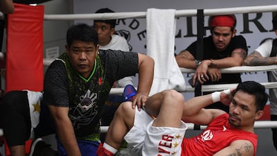 Manny Pacquiao, right, working out under the supervision of long-time friend Nonoy Neri during a training session at a gym in Manila, ahead of his world welterweight boxing championship bout against Argentina's Lucas Matthysse in July. Ted Aljibe / AFP