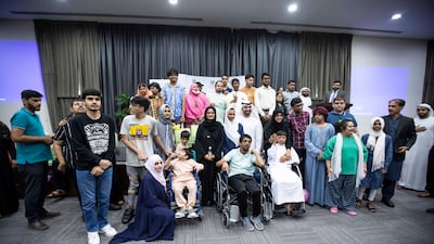 Influencers Khalid Al Ameri and his wife Salama Mohamed pose with children of determination at Dar Al Ber Society's headquarters in Dubai. All photos: Ruel Pableo / The National