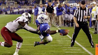 Kentucky tailback Raymond Sanders dives into the end zone for a touchdown despite the efforts of South Carolina strong safety Brison Williams during the first half of an NCAA college football game in Lexington, Kentucky. Gary Jones / AP Photo