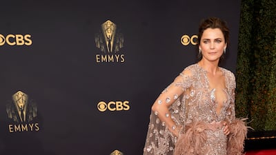 Keri Russell in a Zuhair Murad couture gown in rose mauve with feathers surrounding the hem of a caped back. AP