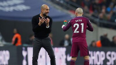 Manchester City's David Silva receives instructions from manager Pep Guardiola. Andrew Couldridge / Reuters