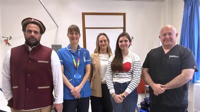 Aliza Rae AliKhan, second right, with, from left, her father Faiysal AliKhan, spinal cord injury nurse specialist Jo Newman, Aliza Rae's mother Thirza AliKhan and consultant spinal surgeon Evan Davies. PA