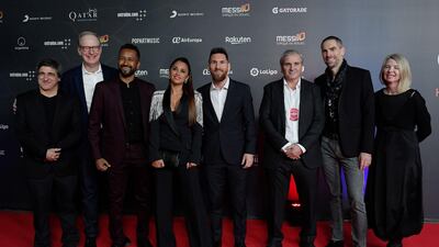 Messi and his wife Antonella pose with director Mukhtar Omar Sharif Mukhtar, third left, and other Cirque du Soleil personnel on the red carpet. AFP