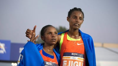 Winner of the 10km race women’s division Abeba Ejigu, right, and Emily Chebet at the Adnoc Abu Dhabi Marathon. Leslie Pableo for The National