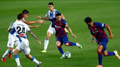 Barcelona's Lionel Messi runs with the ball against Espanyol's Marc Roca, Fernando Calero and Bernardo Espinosa, left. AP Photo