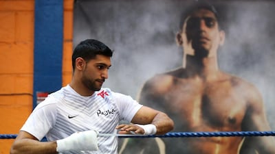 Amir Khan's professional record as a boxer is 29 wins 3 losses. Alex Livesey / Getty Images