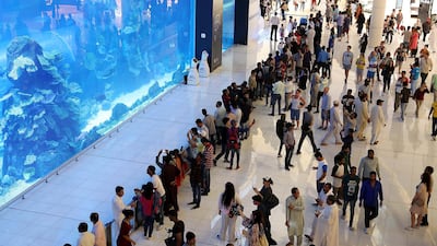 Crowds throng at the Dubai Aquarium on Eid Al Fitr holiday at Dubai Mall. Emaar Malls said second quarter net profit rose 15 per cent.