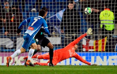 Espanyol's Spanish forward Gerard Moreno, left, scores a late winner against Real Madrid at the RCDE Stadium in Cornella de Llobregat. Josep Lago / AFP