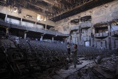Displaced Palestinian children inspect the ruined auditorium of Gaza city's Islamic University on April 16. Chronic stress rewires young brains and bodies, making them more vulnerable to lasting psychological and physical harm. AFP