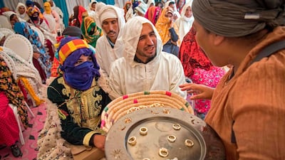 Young Amazigh (Berber) men and women wait to exchange rings during the annual Engagement Moussem festival in Morocco. Photo: Fadel Senna / AFP
