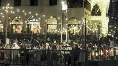 Revellers arrive at Dubai Mall to watch the fireworks at Burj Khalifai. Pawan Singh / The National