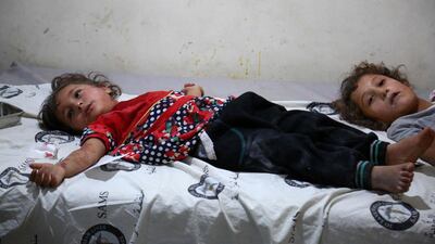 Syrian girls in a makeshift clinic after bombardment on the rebel held area of Tallmannis in Idlib governorate August 20, 2019. AFP